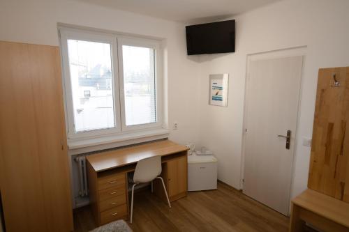 a home office with a desk and a window at Wellness Vila Bohemia in Prague