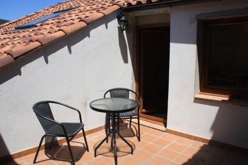 two chairs and a table on a patio at Apartamentos Rurales Altuzarra in Ezcaray