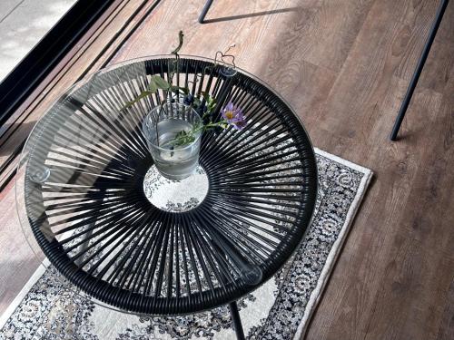 a glass table with a vase with a flower in it at Vacation House Day in Naoshima