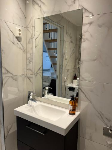 a bathroom with a sink and a mirror at Semesterlägenhet Wettervy in Gränna
