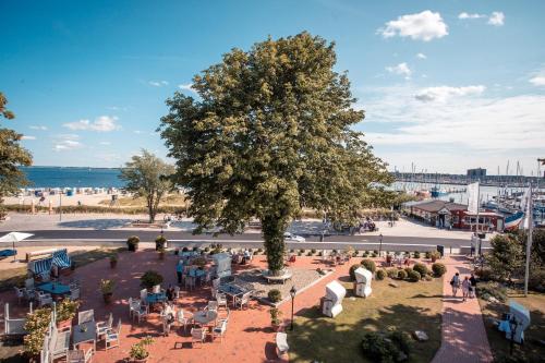 an overhead view of a park with a tree at Strandhotel Strande in Strande