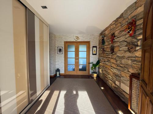 a hallway with a stone wall and a door at Finca Gonzalez in Deva