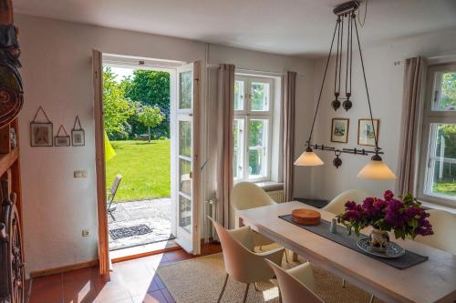a kitchen and dining room with a table and chairs at Jasmundhus in Neddesitz