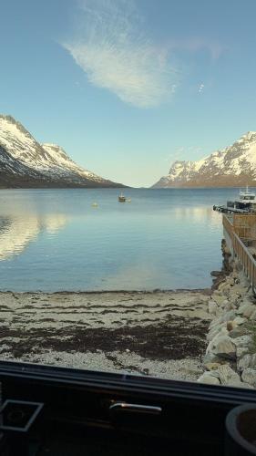 a view of a lake with snow covered mountains at House of Ellie in Ersfjordbotn