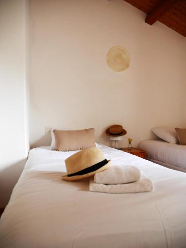 a bedroom with a white bed with a towel on it at Le Parc des Mimosas in Noirmoutier-en-l'lle