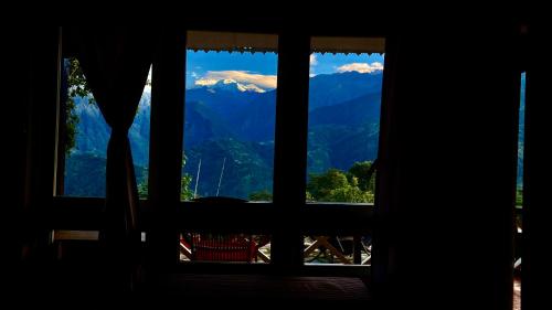 a view from a window of a mountain view at MayaTels - Maya Eco Huts, Pelling in Pelling