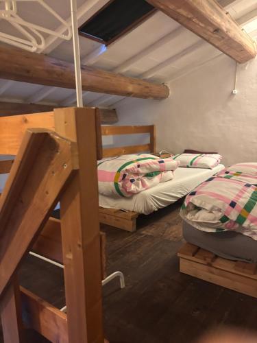 two bunk beds in a room with wooden ceilings at La Fratta Art - House in Marsciano