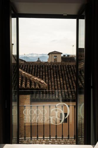 a window with a view of a roof at Corral del Carbón GG Luxury Hotel Boutique in Granada