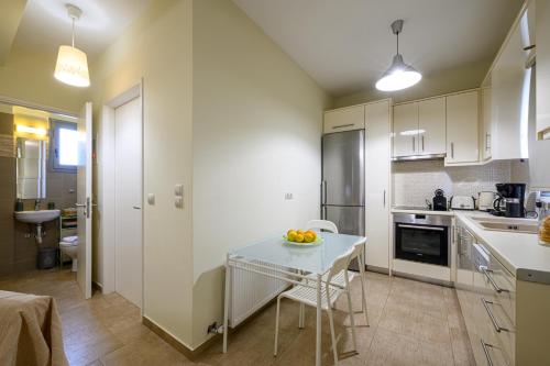 a kitchen with a table with a bowl of fruit on it at Villa Olivia in Koroni