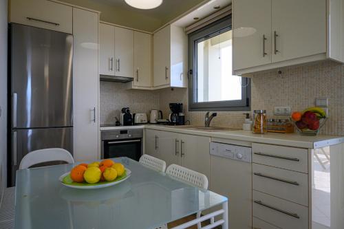 a kitchen with a bowl of fruit on a table at Villa Olivia in Koroni