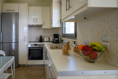 a kitchen with a bowl of fruit on a counter at Villa Olivia in Koroni