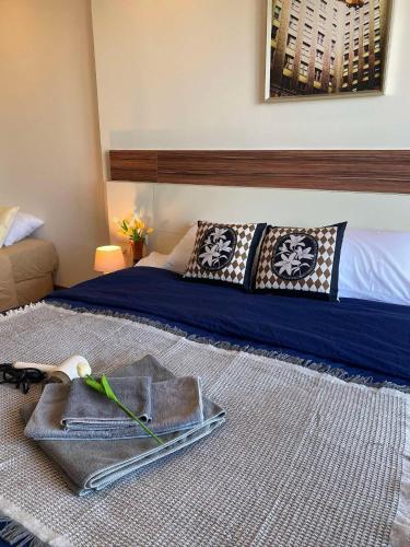 a bedroom with a bed with a tray on the floor at The Astra Luxury Condo near old town in Chiang Mai