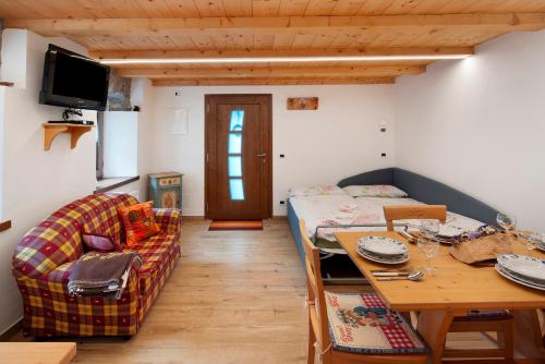 a small living room with a table and a couch at La Casa di Bryan in Piaia