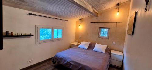 une petite chambre avec un lit et deux fenêtres dans l'établissement Villa Provençale Harmonie 8 Guest poolhouse, à Lambesc