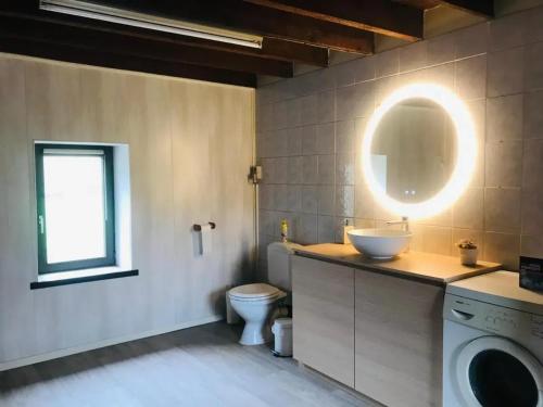 a bathroom with a sink and a washing machine at Family home in Thon, garden and terrace 100 m² in Namêche