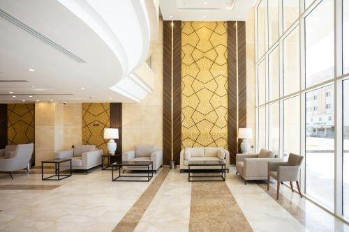 a lobby with couches and chairs in a building at Hotel SDU BOUTIQUE in Al Madinah