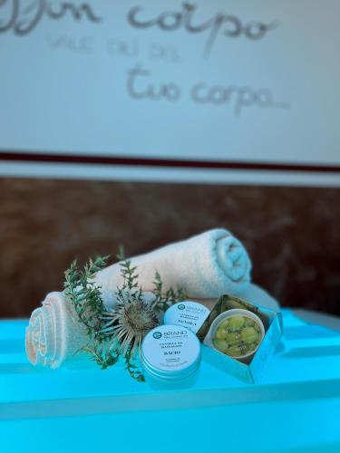 a blue table topped with a box and a towel at Hotel Europa in San Martino di Castrozza