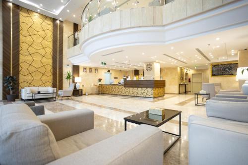 a lobby of a hotel with couches and a counter at Hotel SDU BOUTIQUE in Al Madinah