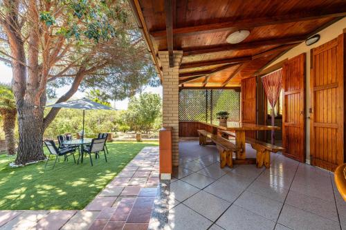 a porch of a house with a table and chairs at Villa Lidia vicino al mare in Solanas