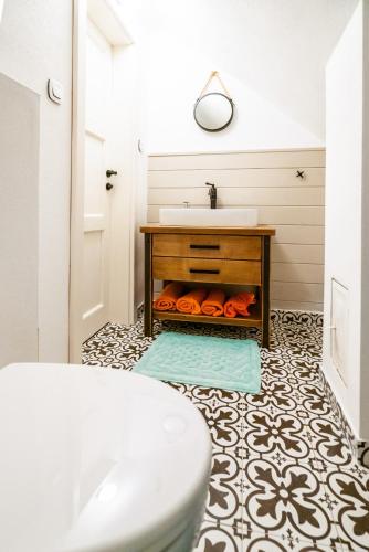 a white bathroom with a sink and a counter at Chalupa pod Sixovkou in Krupina