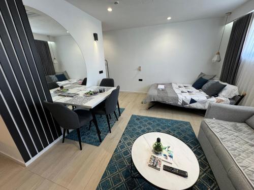 a living room with a table and a couch at Golden Soul Sarajevo Old town - Walk everywhere in Sarajevo