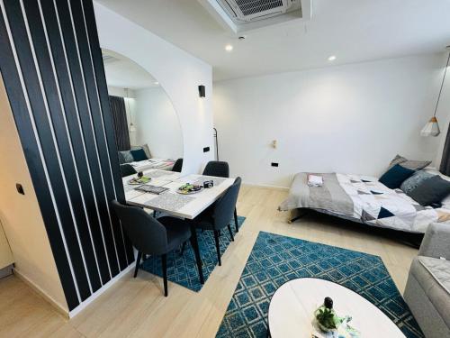 a living room with a table and a bed at Golden Soul Sarajevo Old town - Walk everywhere in Sarajevo