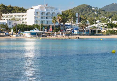 a large body of water with a building in the background at Apartamentos La Kiki in San Antonio Bay