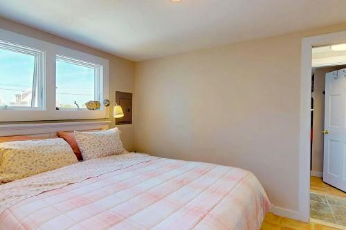 a bedroom with a bed and a window at Anchorage Escape in Truro