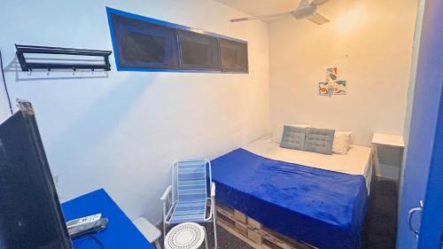 a small room with a bed and a television at Santorini House in Bali Near Airport in Kuta