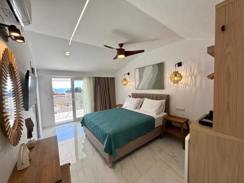 a bedroom with a bed and a ceiling fan at Villa Antonis in Parga