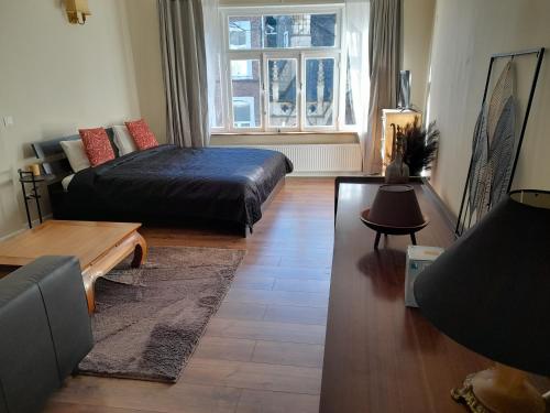 a living room with a bed and a couch at La porte in Huy