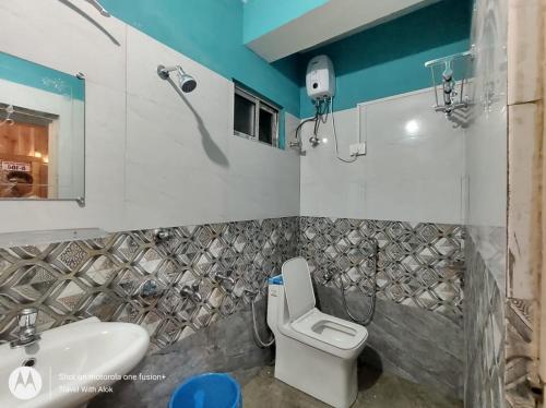 a bathroom with a toilet and a sink at Kacey Homestay Ramdhura in Rangpo
