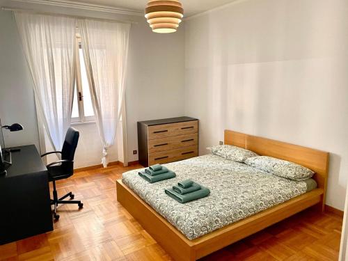 a bedroom with a bed with two green towels on it at Downtown Milan Chic Apartment - Quiet Retreat with Free WIFI & Air Conditioning in Milan