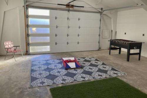 a room with a ping pong table and a rug at The Sinatra in Bentonville