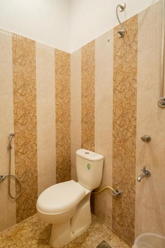 a bathroom with a toilet and a shower at MGM Whispering Nest Yelagiri in Yelagiri