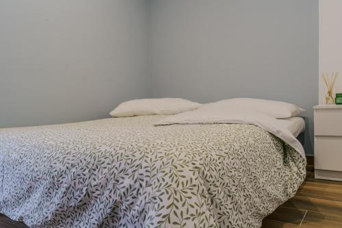 a bed with two pillows on it in a bedroom at Domus-Pulchra in Bari