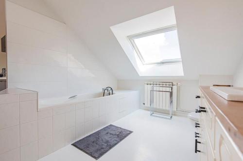 une salle de bain blanche avec un lavabo et une baignoire dans l'établissement Suite Champagne, à Épernay