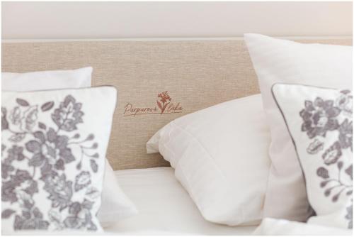 a bed with white pillows and a sign on it at Chalupa Purpurová lúka Velké Karlovice in Velké Karlovice