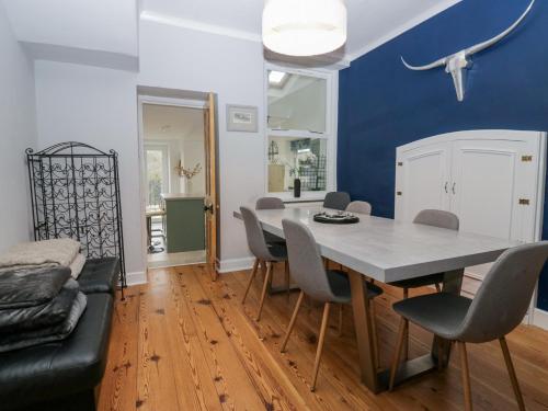 a dining room with a table and chairs at Willow Cottage in Carnforth