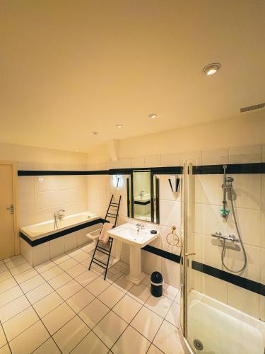une salle de bain avec une baignoire, un lavabo et une douche dans l'établissement So Chic- appartement cœur de ville 4 chambres, à Béziers