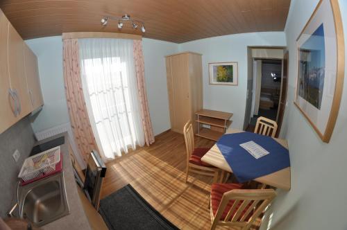a small room with a table and a dining room at Apparthotel Bliem in Schladming