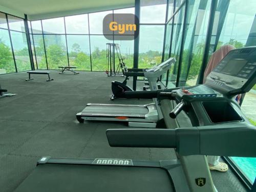 a gym with cardio equipment in a building at Gardens peace Hatyai in Hat Yai