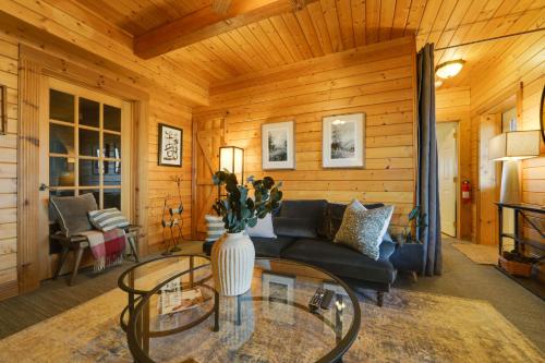 a living room with a couch and a glass table at Secluded Mtn-View Retreat in Mars Hill in Mars Hill