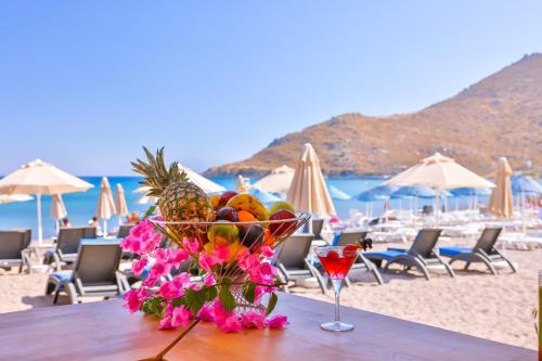 a bowl of fruit on a table at a beach at Mare Garden Hotel in Akyarlar