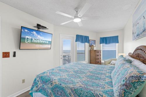 a bedroom with a bed and a flat screen tv at Boardwalk 983 in Gulf Shores