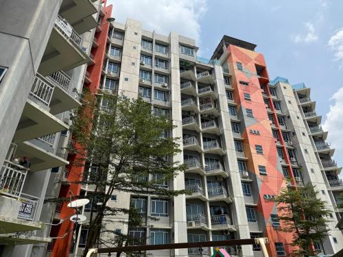a tall apartment building in a city at Bright Apartment in Klebang in Ipoh