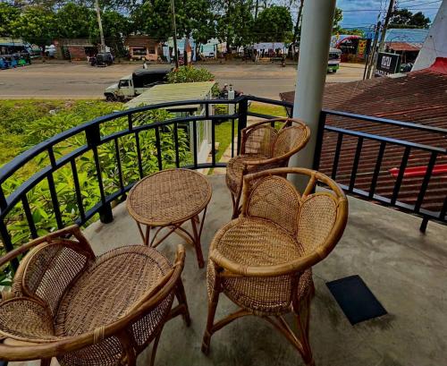 a group of chairs and tables on a balcony at Mahaon surf hotel in Weligama