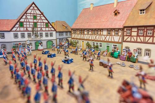 a toy model of a medieval town with a group of people at Flair Hotel zum Storchen in Bad Windsheim