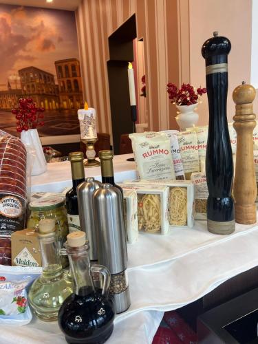 a table with bottles of wine and other items on it at Hotel Les Jardins Carol in Bucharest
