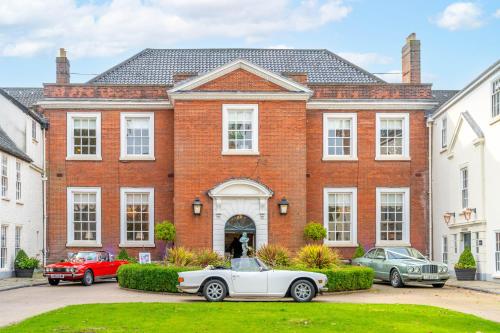a white car parked in front of a brick house at The Assembly House in central Norwich in Norwich